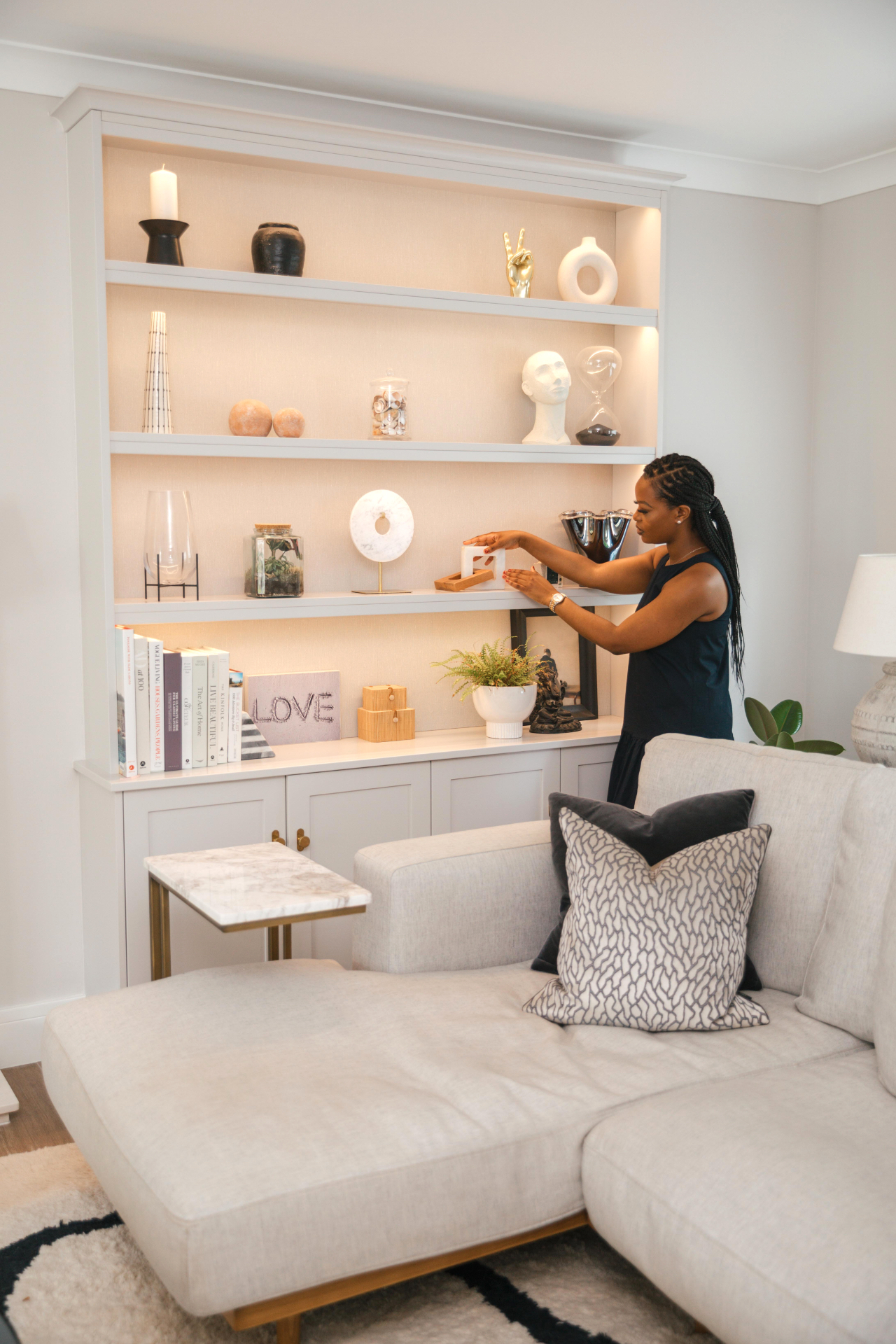 Shuvi Muregi styling a shelf in a bright neutral room